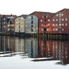 Colorful Weathered Boathouses Reflected in Calm Water