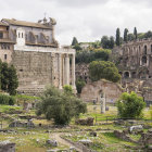 Roman ruins painting with grand columns, arches, and sculptures in lush garden setting