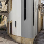 Sunlit Spanish Alley with White Walls and Flower Pots