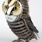 Steampunk-style mechanical owl with metal feathers and clockwork in blue and bronze