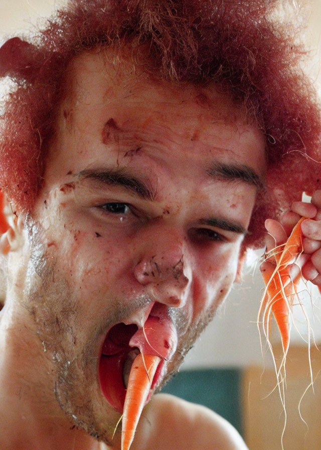 Red-haired person distressed with blood-like substance, biting carrot