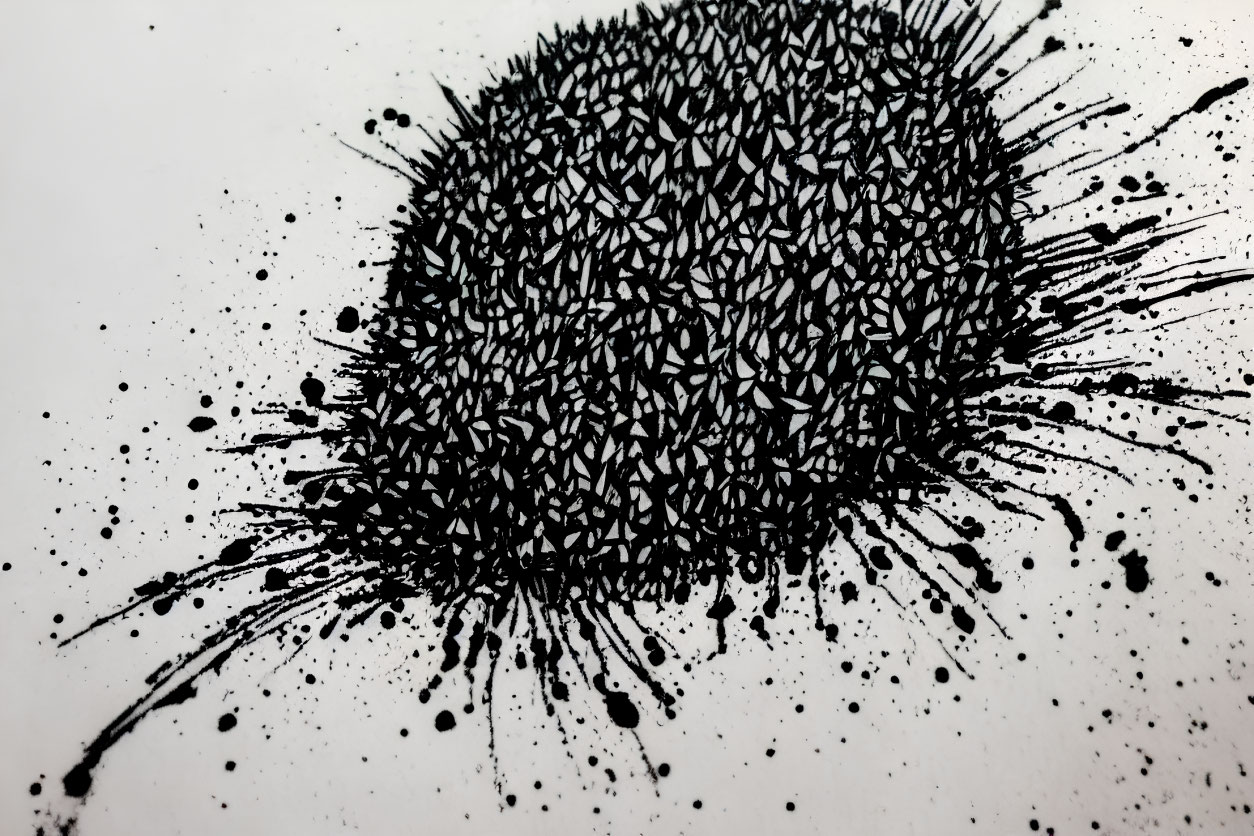 Ink splatter with dense droplets and fine specks on white background