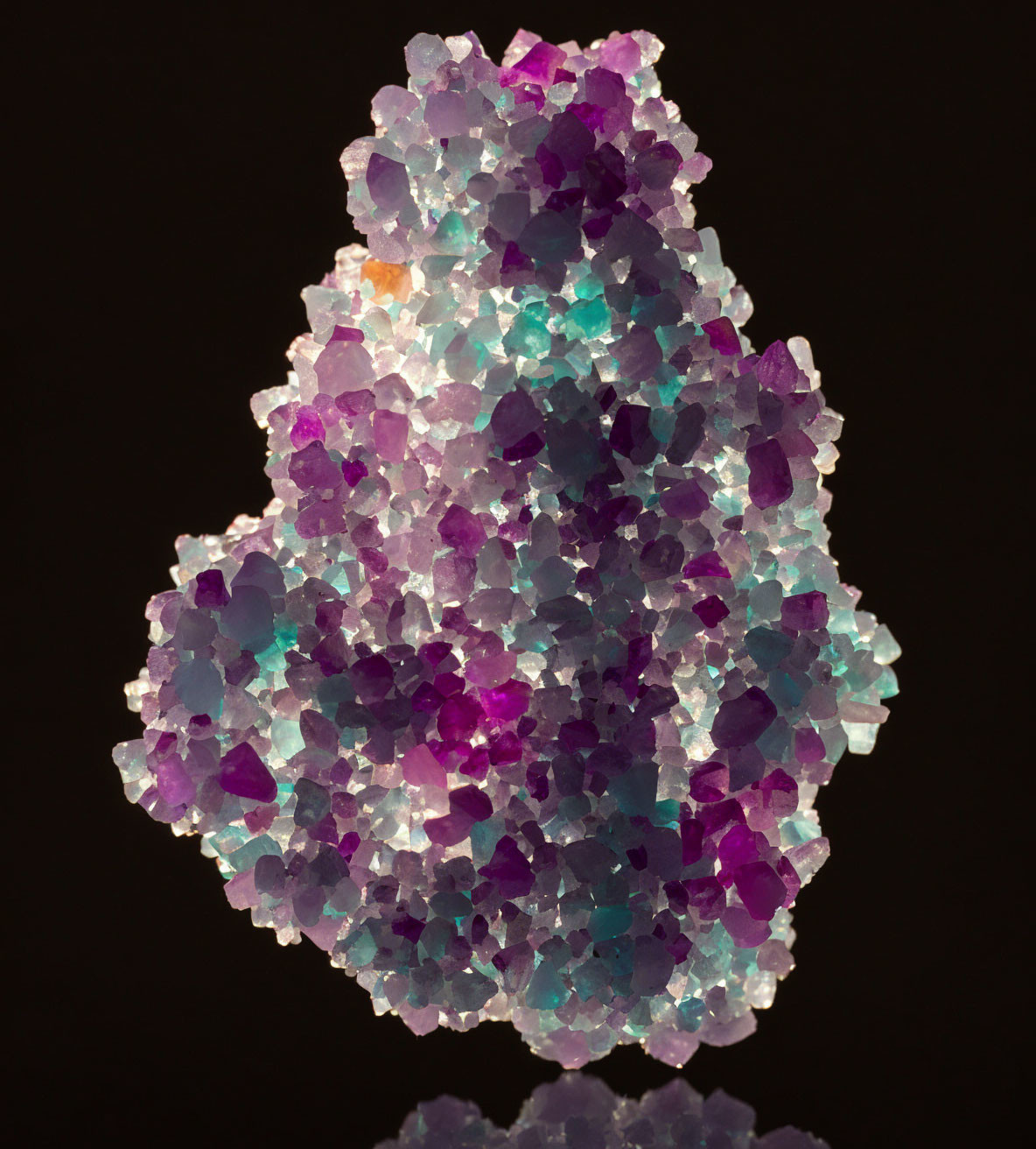 Colorful Purple and Pink Crystalline Minerals on Dark Background