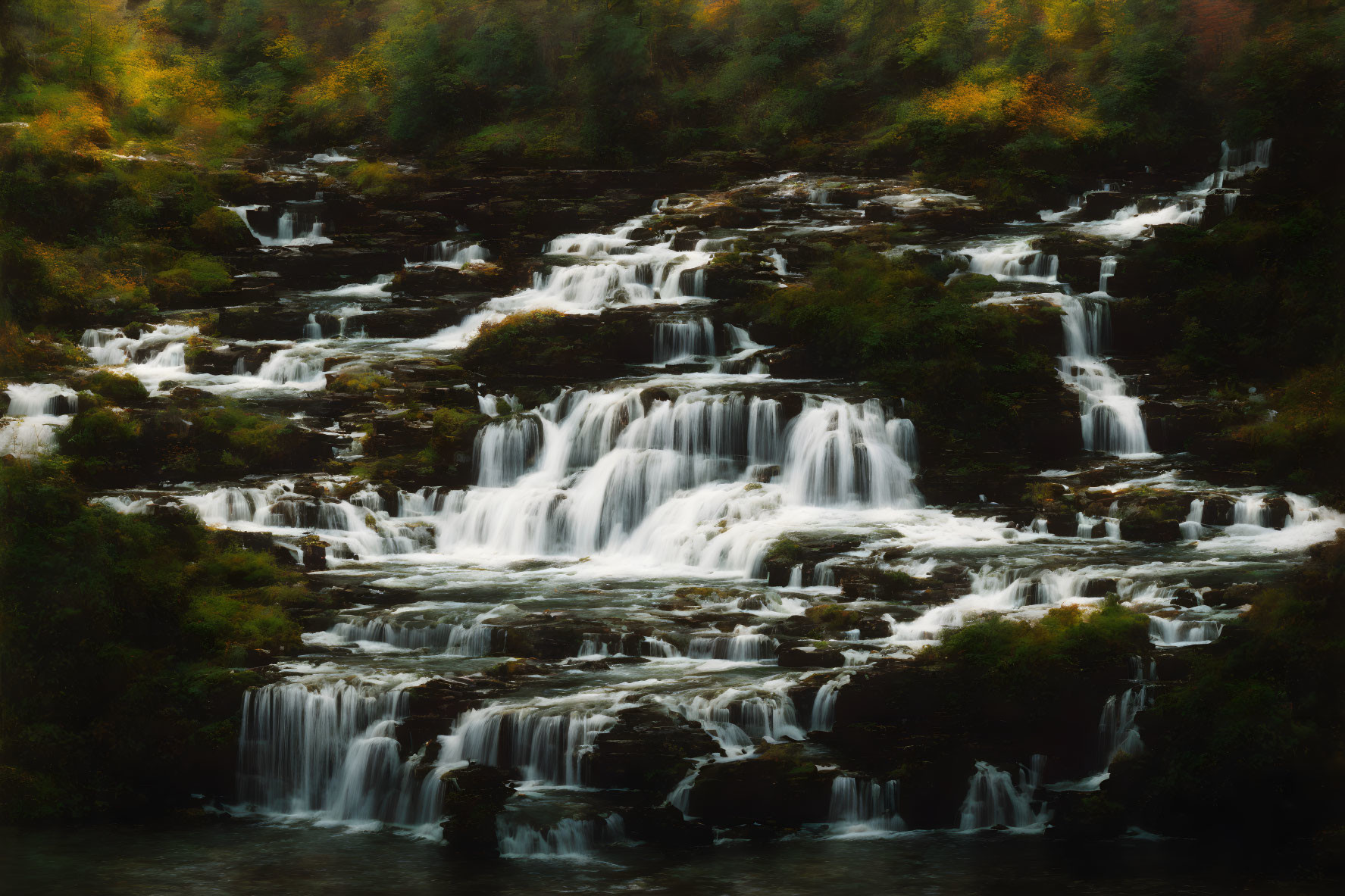 Tranquil multi-tiered waterfall in autumn setting