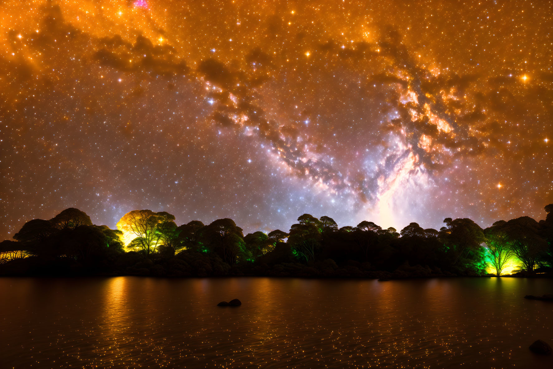 Vibrant Milky Way over silhouetted trees by tranquil lake