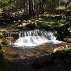 Tranquil multi-tiered waterfall in autumn setting