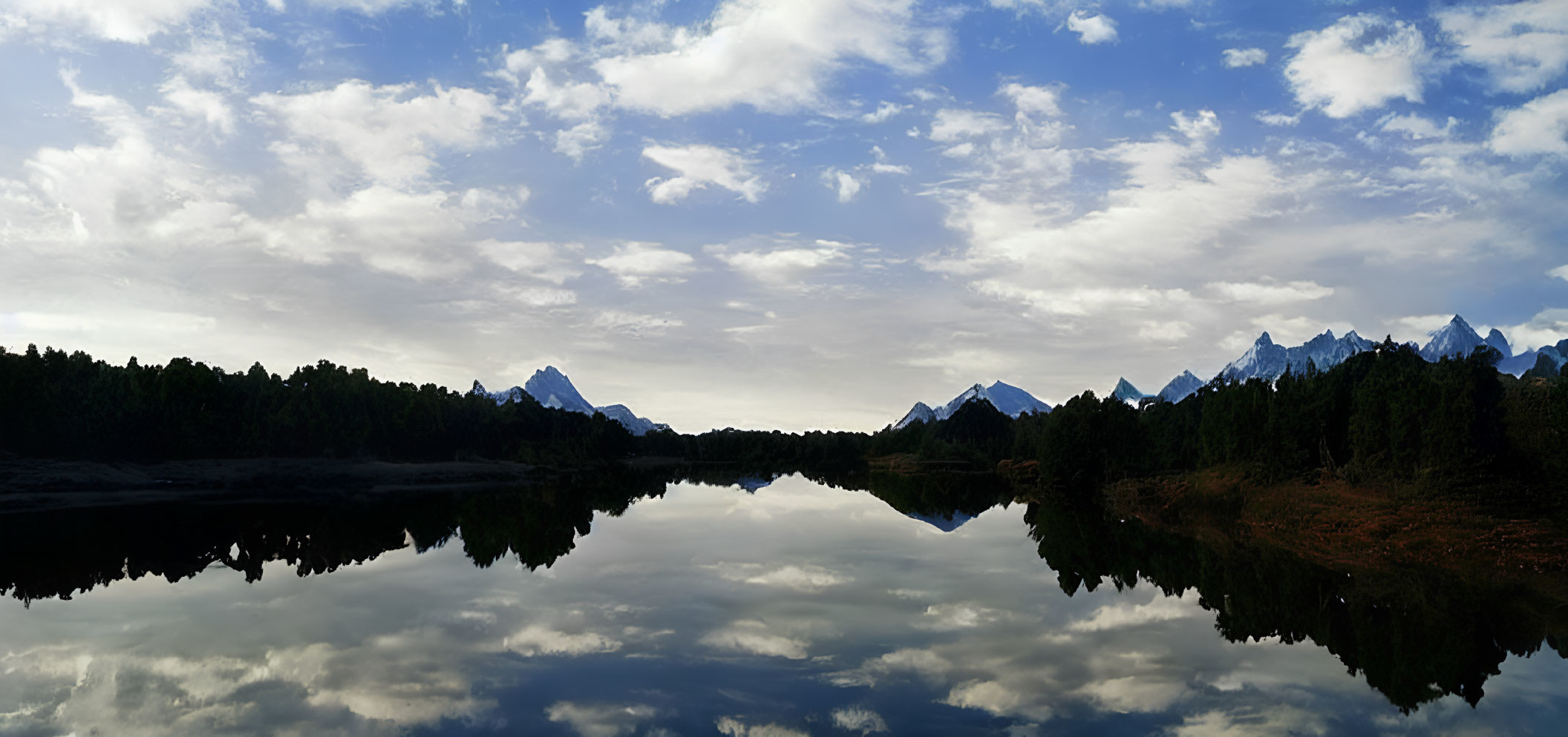 Tranquil Lake with Clouds, Mountains, and Blue Sky