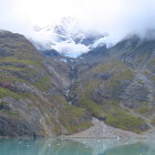 Snow-capped mountain peak in misty alpine landscape