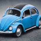 Vintage Blue Car Model with Chrome Details on Gray Background