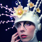 Digital artwork of female astronaut with floral helmet in starry space