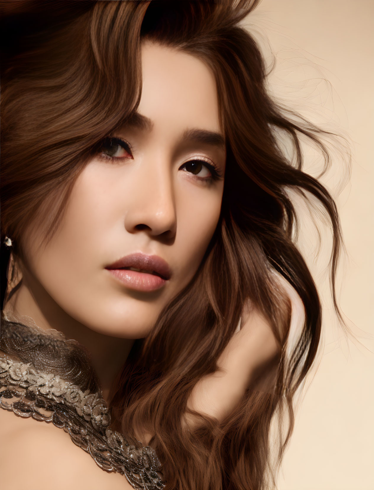 Woman with wavy brown hair and lace garment against beige background