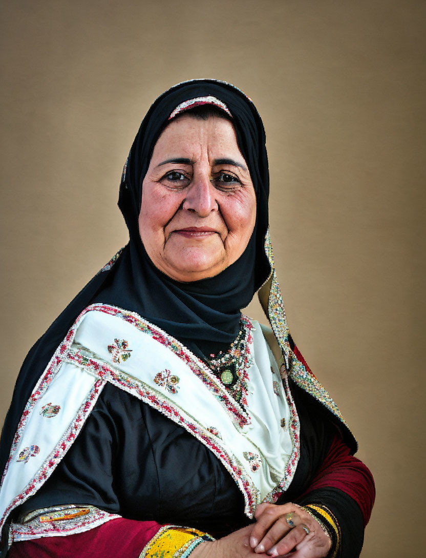 Smiling woman in traditional embroidered shawl and headscarf