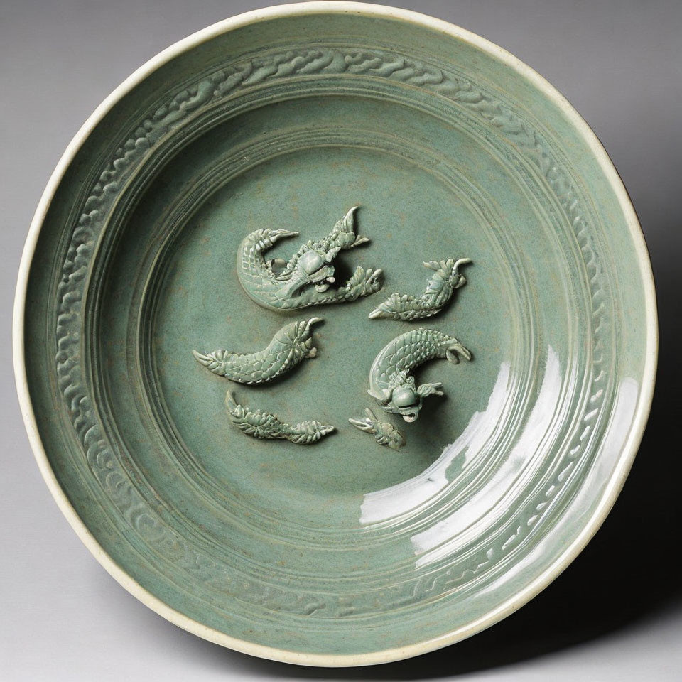 Celadon Plate with Raised Dragon Motifs and Carved Border