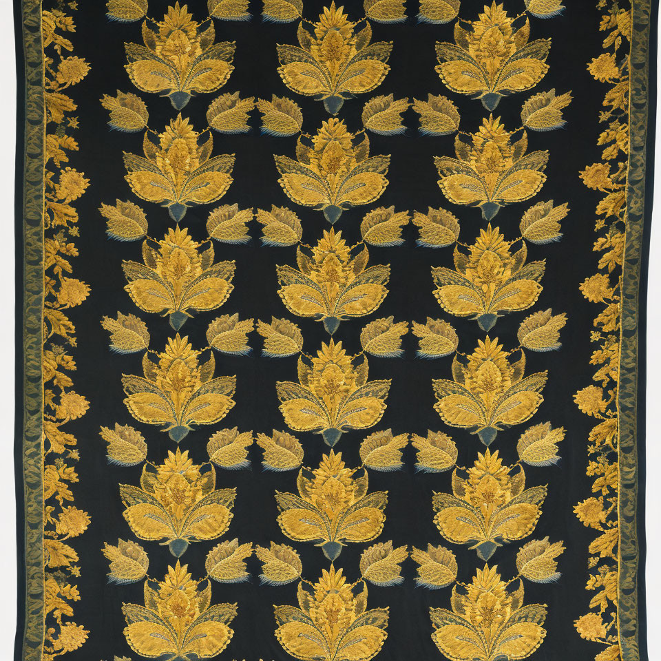 Symmetrical golden leaf patterns on dark fabric against black or blue background