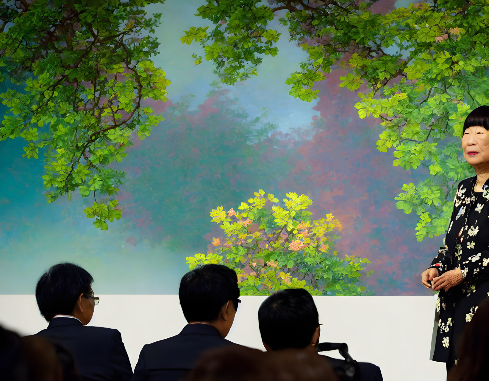 Person presenting against colorful floral backdrop