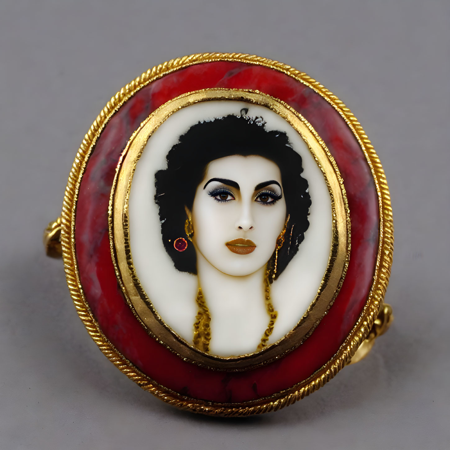 Ornate brooch with painted portrait of woman, gold trim, red and white background