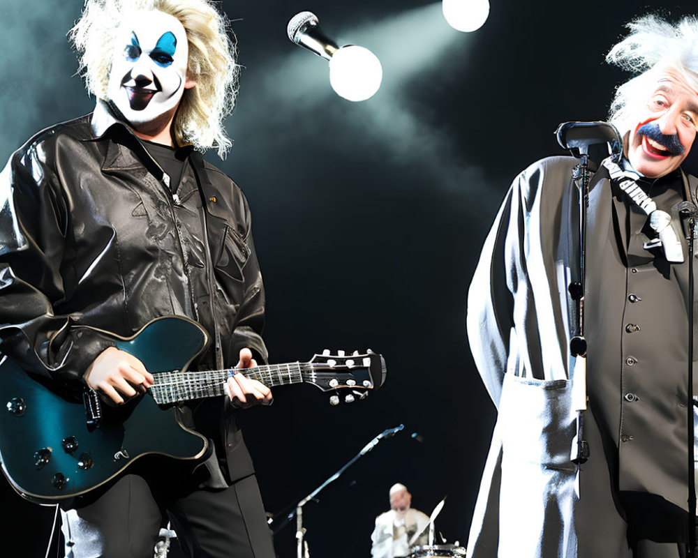 Clowns performing with guitar and singing on stage with drummer