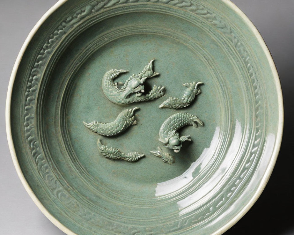 Celadon Plate with Raised Dragon Motifs and Carved Border