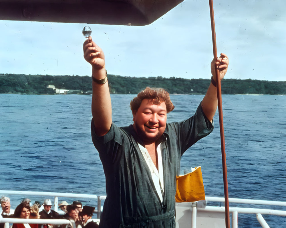 Person holding glass on boat with people on sunny day.