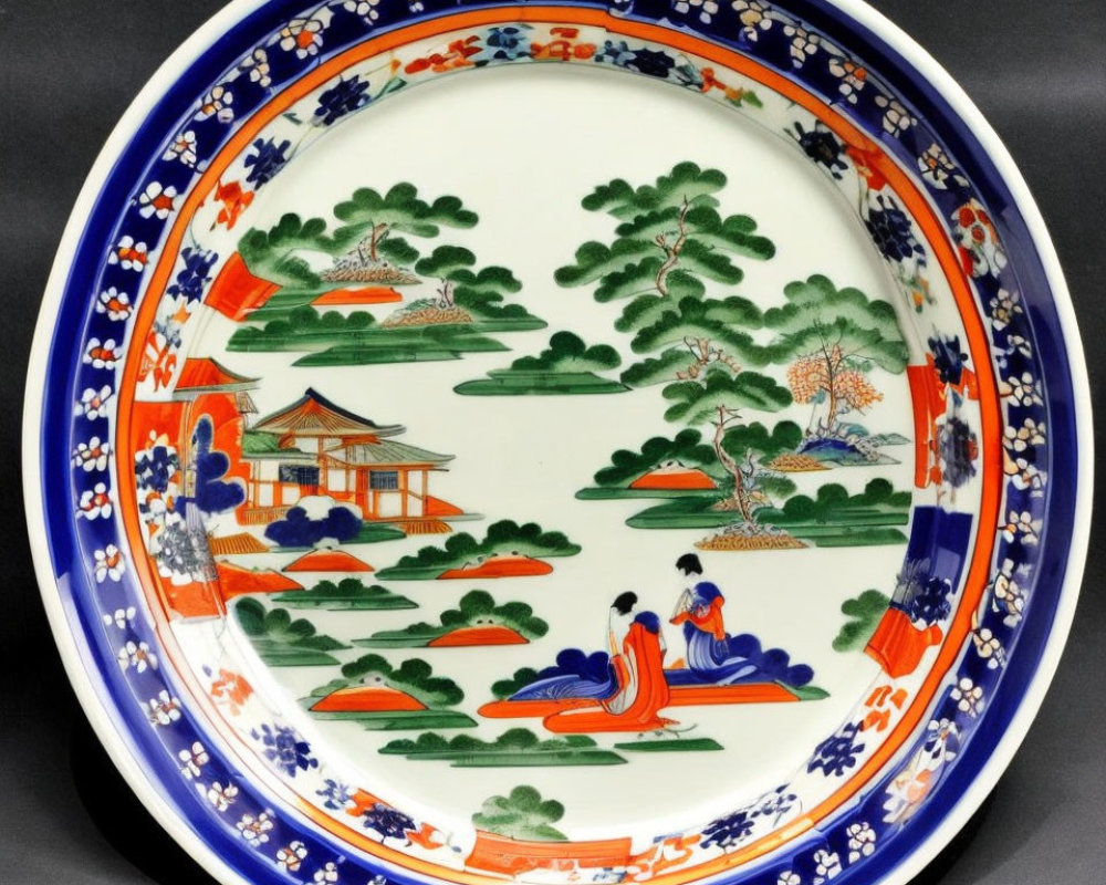 Traditional Asian Garden Scene Ceramic Plate with Figures, Trees, Pavilion, and Floral Border