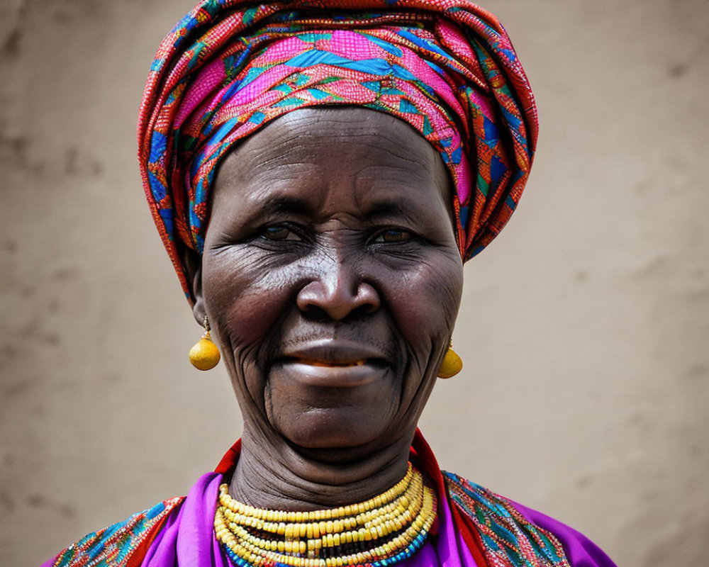 Colorful elderly woman with head wrap, earrings, and beaded necklace on neutral backdrop