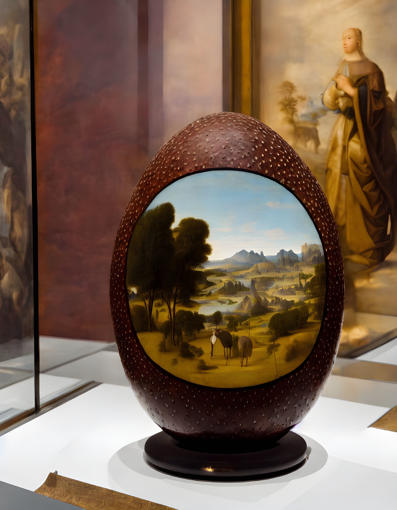 Egg-shaped object with pastoral landscape painting on stand