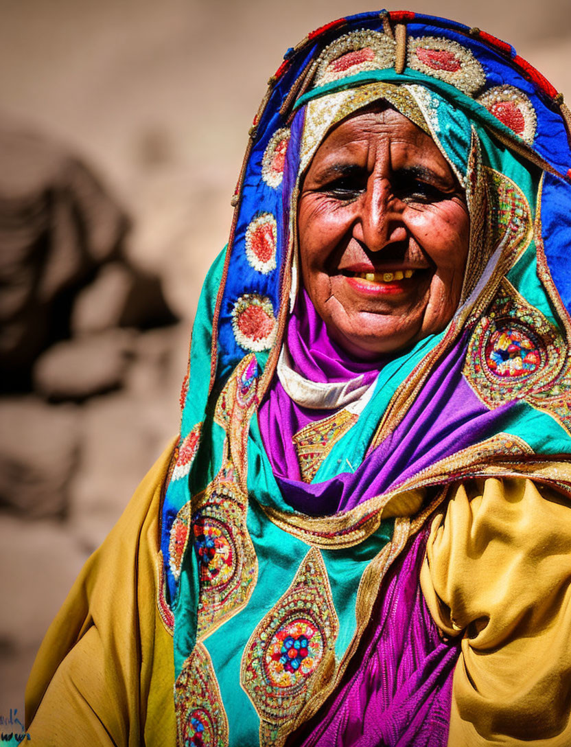 Smiling woman in colorful embroidered headscarf on sunny day