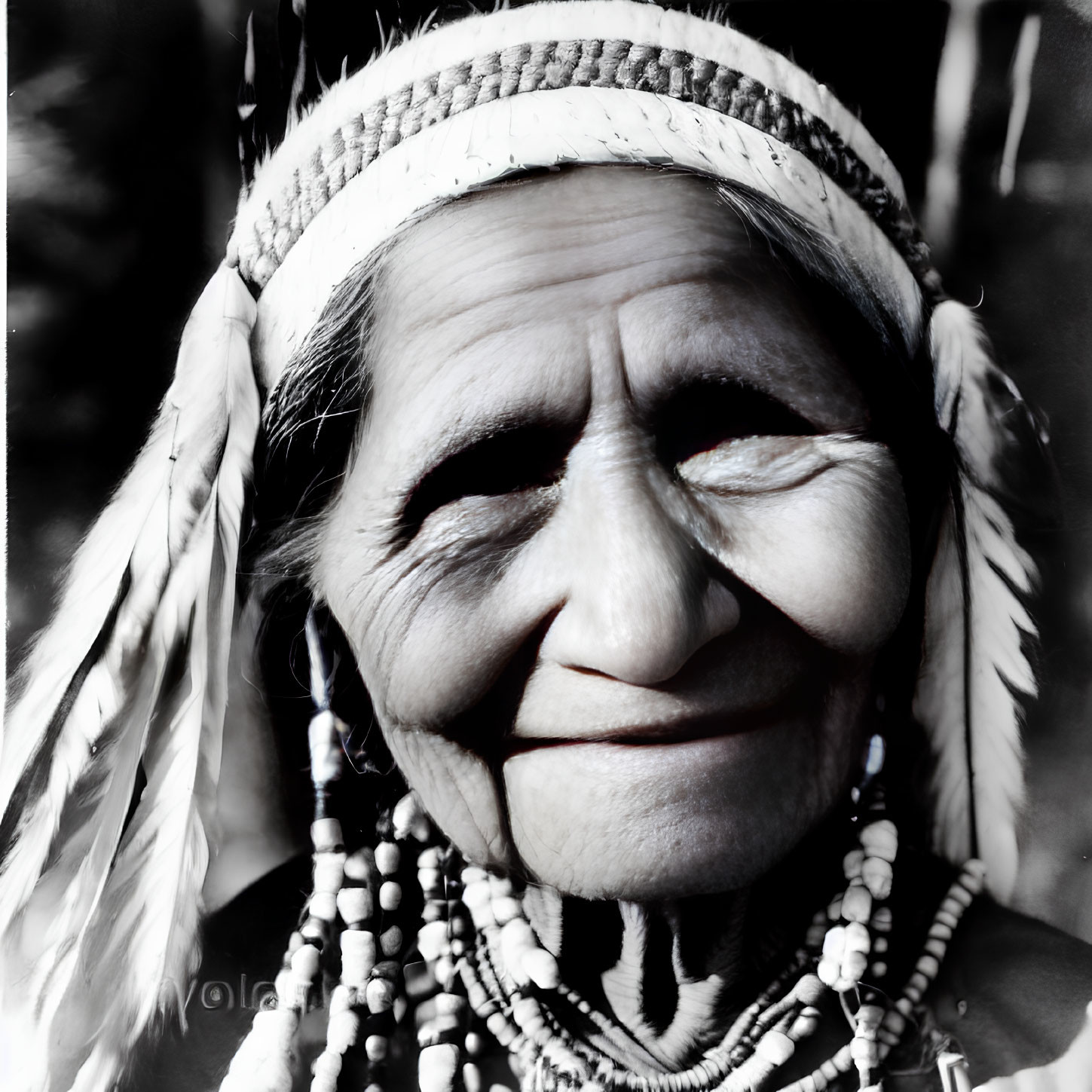 Elderly woman in Native American headdress with feathers and beads