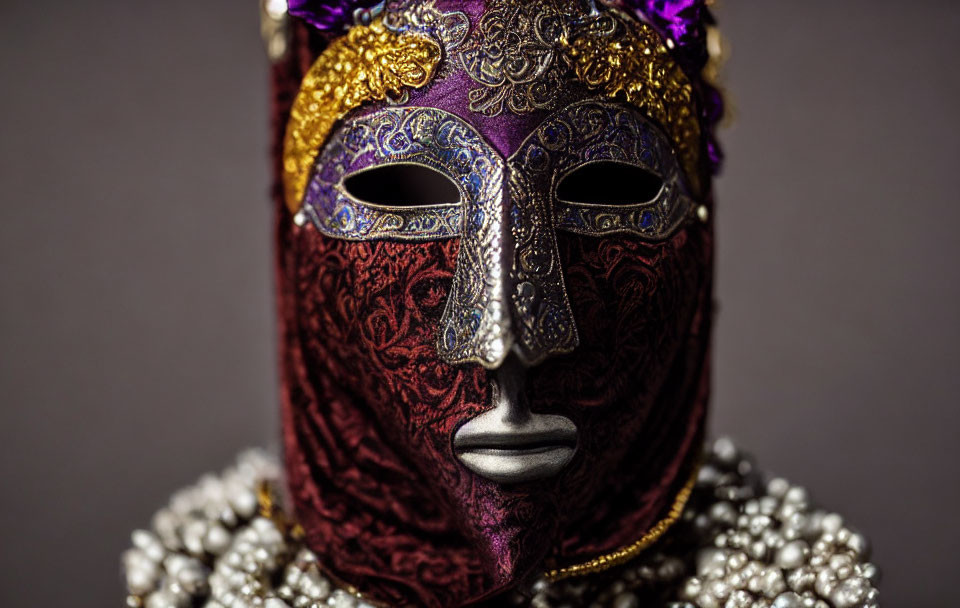 Intricate Purple and Gold Venetian Mask on Gray Background