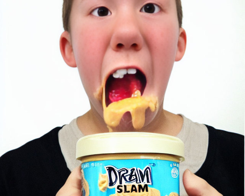 Young boy with peanut butter and "Dream Slam" jar on tongue.