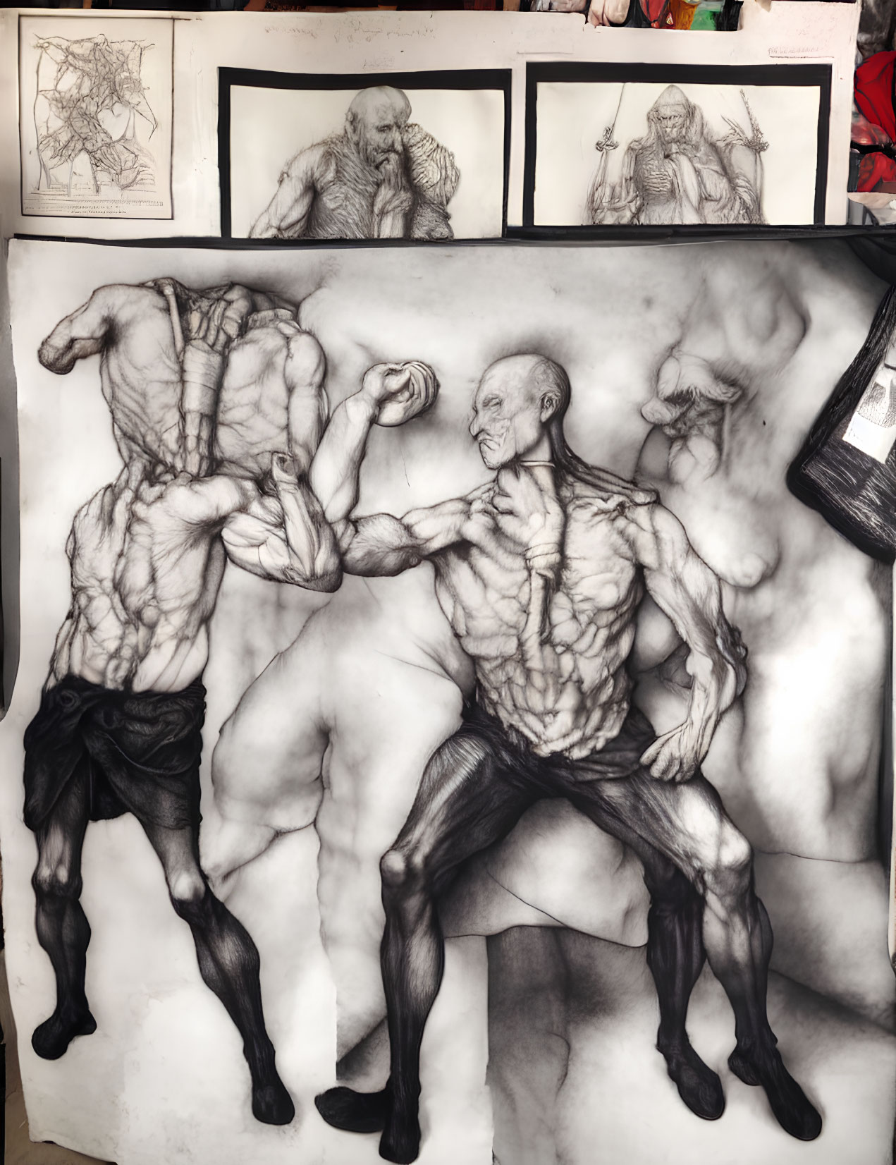 Detailed sketch of two muscular male figures in dynamic poses alongside character drawings in a studio