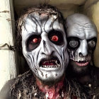 Detailed zombie makeup on two individuals with sunken eyes and bloody wounds, partially obscured by a foreground figure