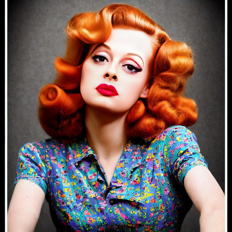 Vibrant red retro-styled hair and bold makeup on woman in vintage blouse