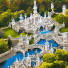 Fantasy landscape with white pagodas, waterfalls, greenery & stones