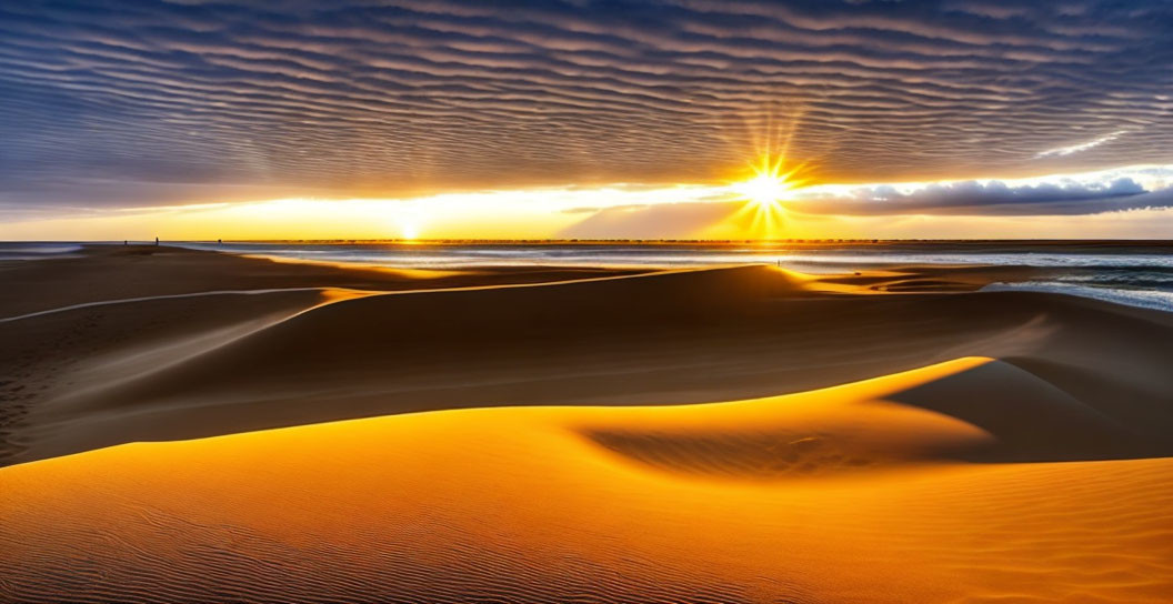 Vivid sunset with sunburst over sand dunes and dramatic sky.