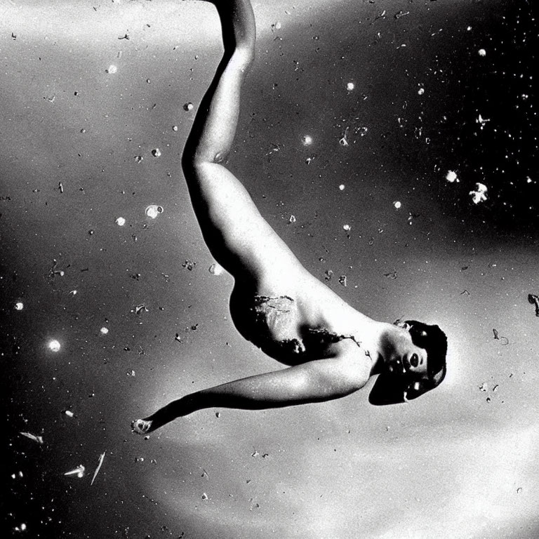 Monochrome image of person floating among debris in space.