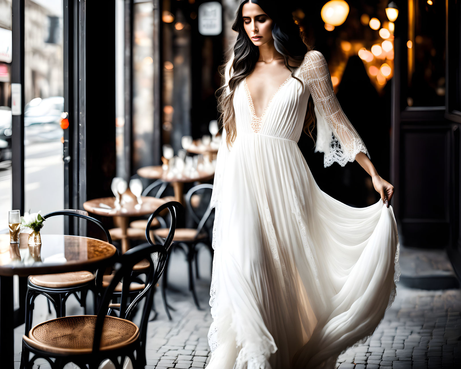 Woman in white lace dress twirls in elegant café