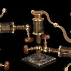 Abstract 3D art: Ornate brass and gold pipes on dark background