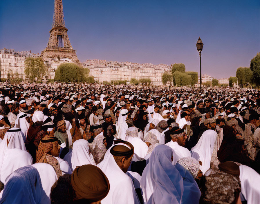 Crowd in white attire with Eiffel Tower backdrop on a sunny day