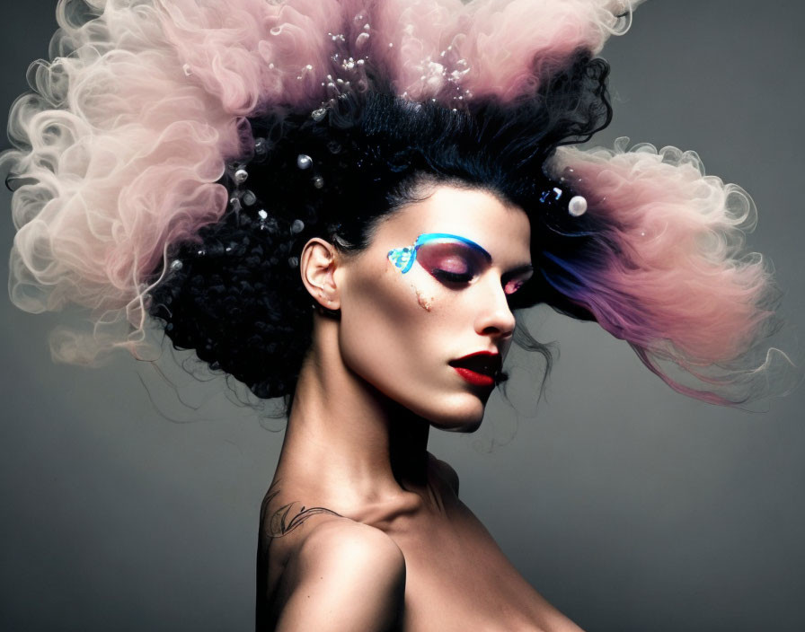 Woman with Dramatic Makeup and Pearl-Adorned Hairstyle on Grey Background