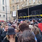 Crowd at Outdoor Concert with Tattoos and Raised Fists