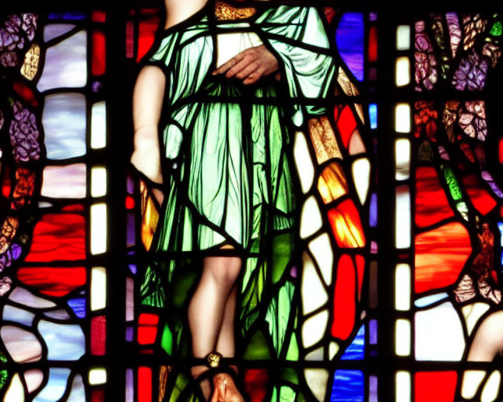 Colorful stained glass window featuring woman in green robes