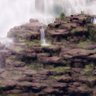 Grand castles on rocky cliffs with waterfalls and mist.
