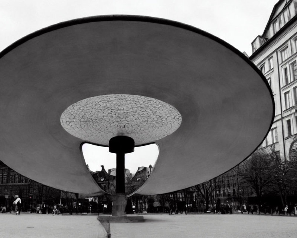 Monochrome urban square with large funnel sculpture