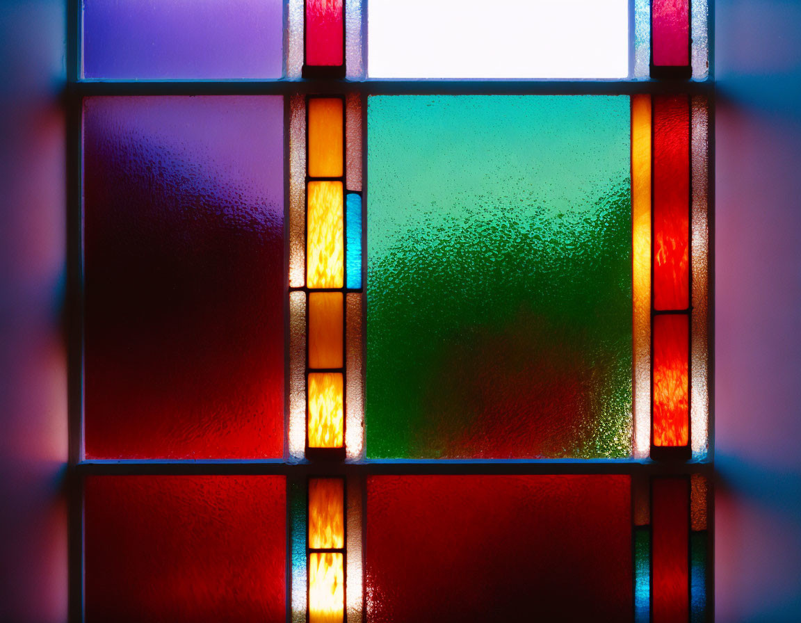 Vibrant red, yellow, and green stained glass window backlight glow