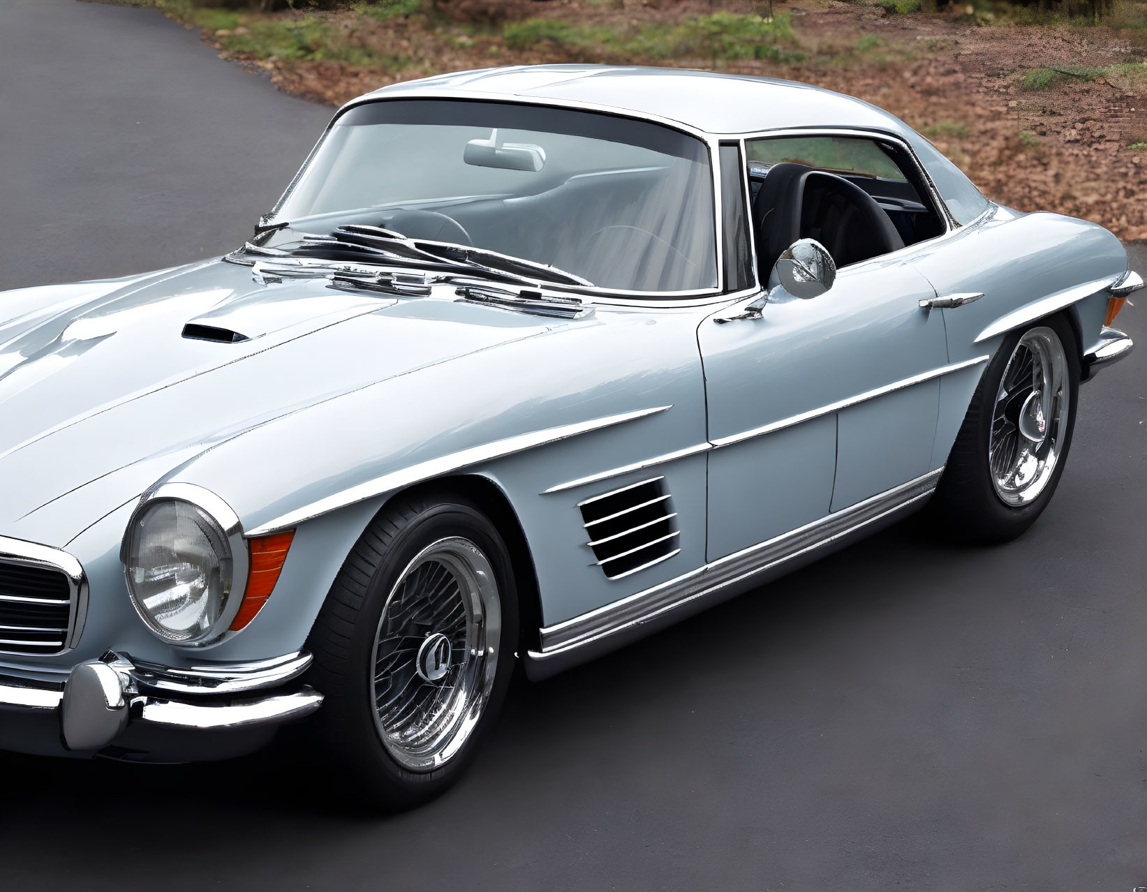 Vintage light blue Mercedes-Benz 300SL with gullwing doors and chrome accents