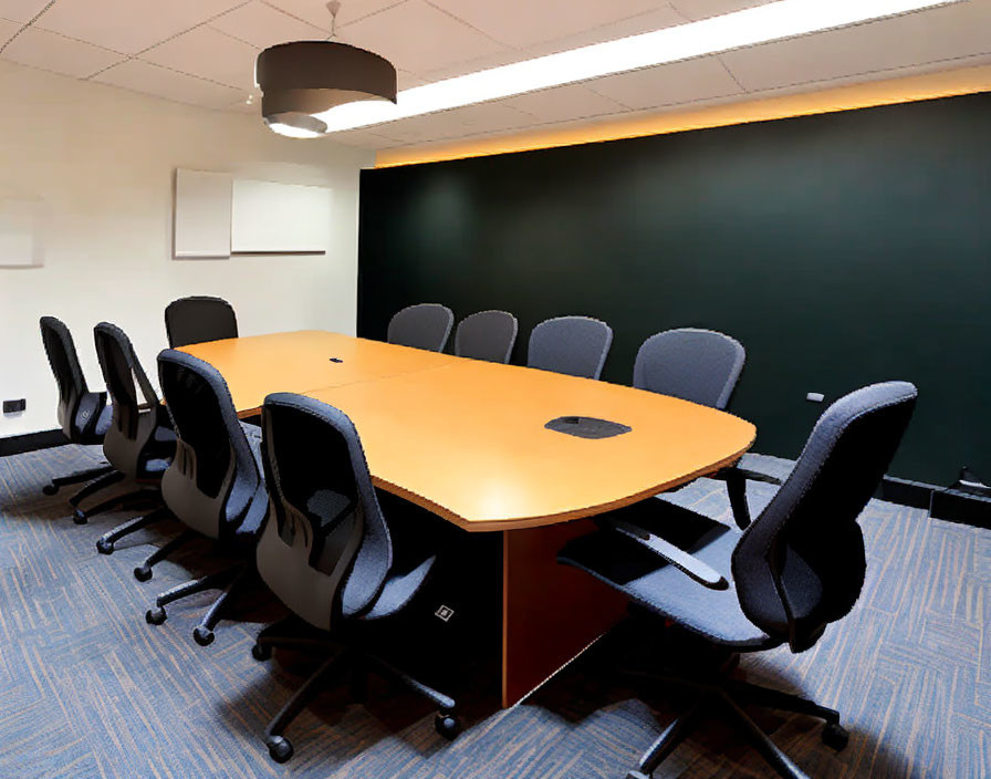 Contemporary conference room with oval wooden table, gray chairs, blackboard, and ceiling light