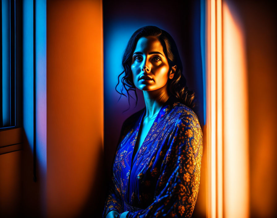 Woman in Blue Dress Contemplating by Window in Contrasting Light