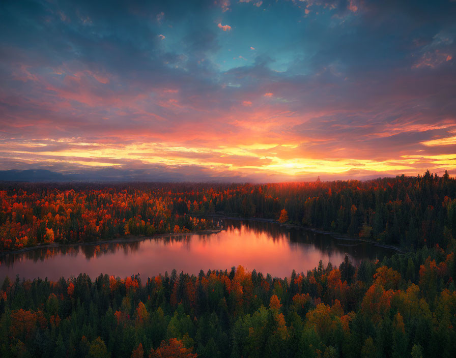 Tranquil sunset over autumn forest and reflective lake