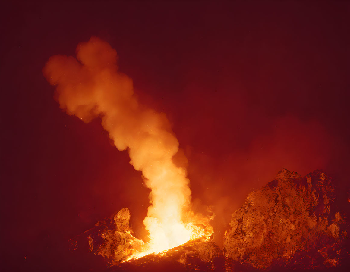 Intense volcanic eruption with bright lava and thick smoke